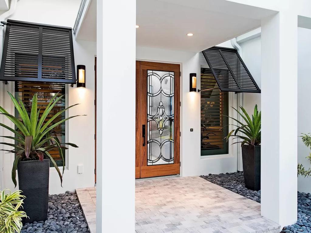 House entrance with Bahama shutters covering the windows.