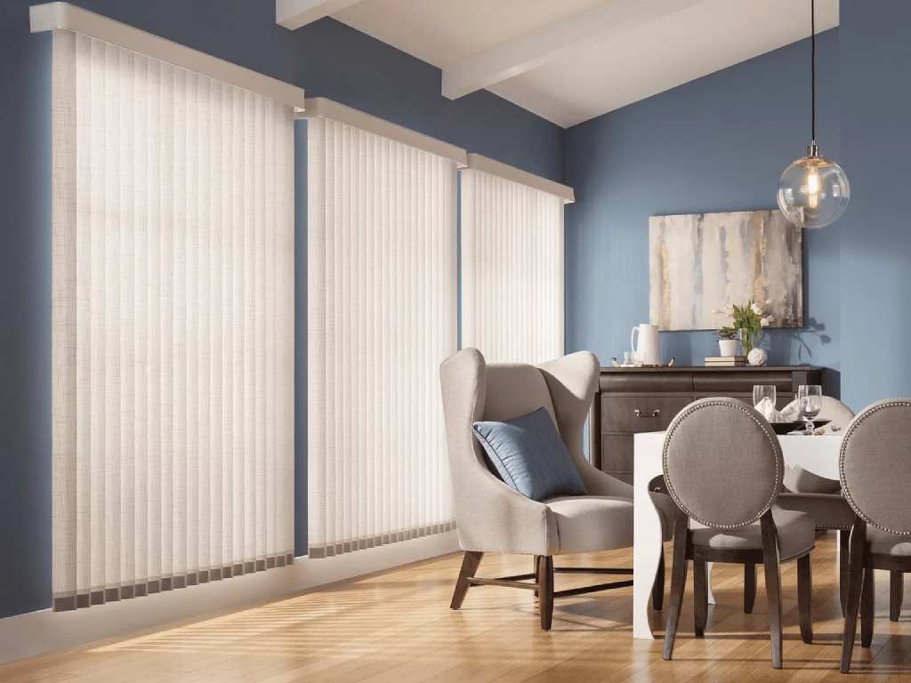 Modern dining room with soft light diffusing through vertical blinds.