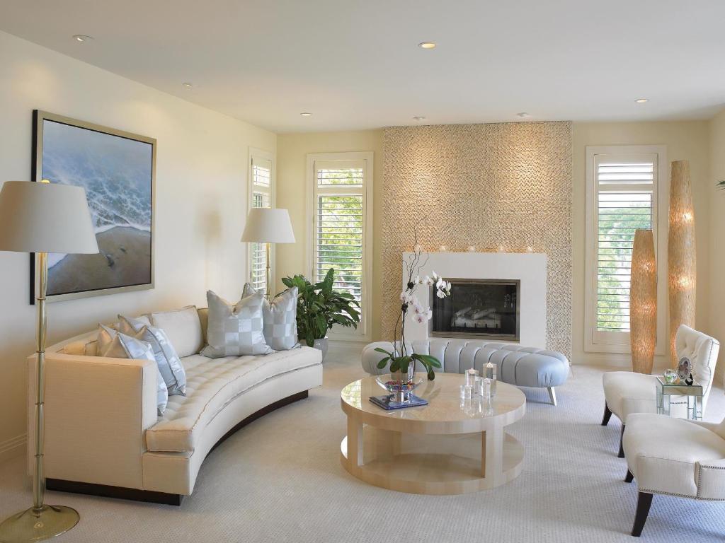 Elegant living room with white plantation shutters covering the windows.