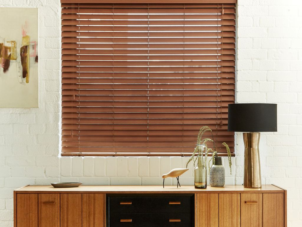 Living room with wood blinds covering the window.