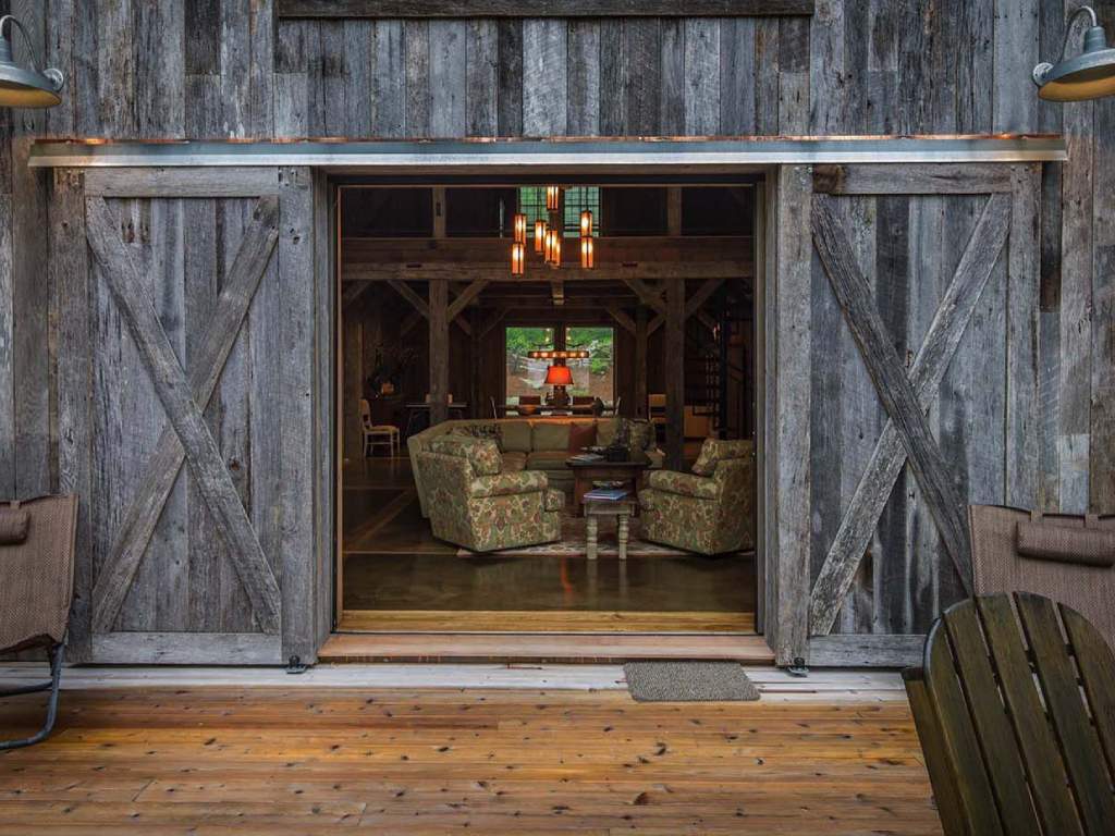 Modern farmhouse living room with rustic sliding barn door.