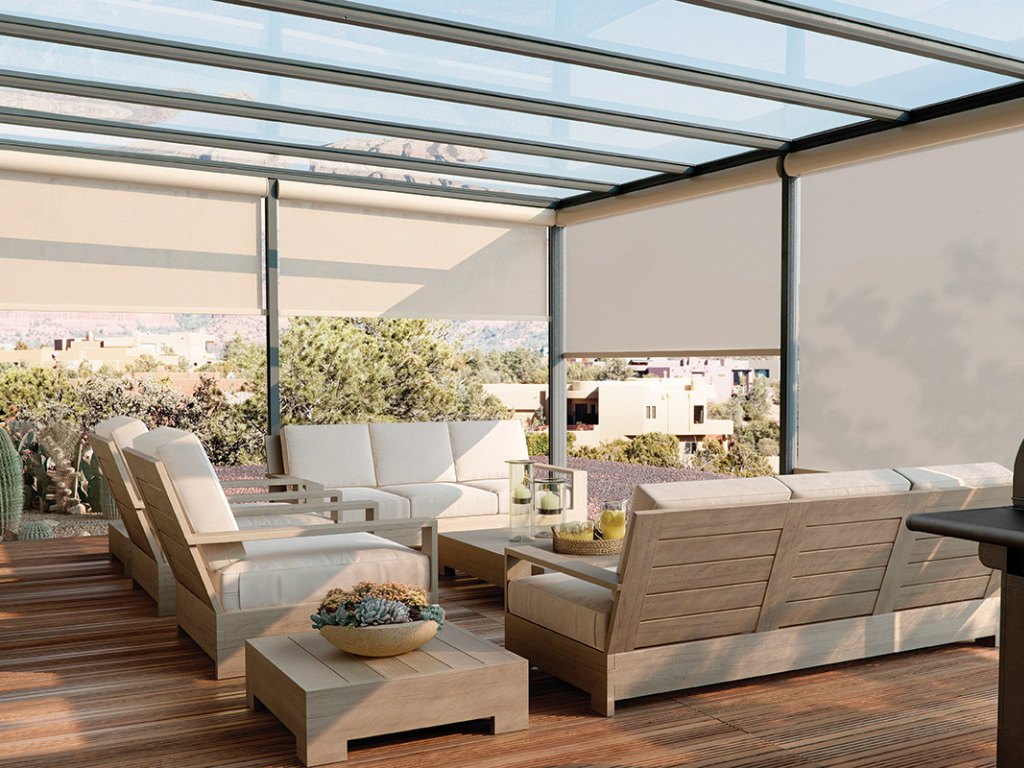 Outdoor patio with comfortable furniture and solar shades providing protection from the sun.